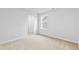Well-lit bedroom with plush carpeting and a view of the walk-in closet at 2750 Lacy Holt Rd, Graham, NC 27253