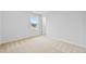 Bright bedroom featuring neutral carpet, a window offering natural light and a white door at 2750 Lacy Holt Rd, Graham, NC 27253