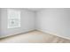 A clean and well-lit bedroom with plush carpet and a window view at 2750 Lacy Holt Rd, Graham, NC 27253