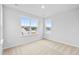 Cozy bedroom with two windows showcasing neighborhood views and neutral carpeting at 2750 Lacy Holt Rd, Graham, NC 27253