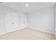 Cozy bedroom with carpeted floors, light walls, and double door closet at 2750 Lacy Holt Rd, Graham, NC 27253