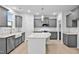 Bright kitchen featuring gray cabinetry, a central island with granite countertop, and stainless steel appliances at 2750 Lacy Holt Rd, Graham, NC 27253