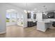 Bright open-concept kitchen with gray cabinets, stainless appliances, farmhouse sink, and large island at 2750 Lacy Holt Rd, Graham, NC 27253