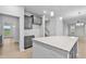 Bright kitchen features gray cabinets and large island with stone countertop at 2750 Lacy Holt Rd, Graham, NC 27253