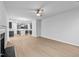 Bright open-plan living room featuring hardwood floors, fireplace, and connecting kitchen at 2750 Lacy Holt Rd, Graham, NC 27253