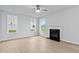 Bright living room with hardwood floors, a ceiling fan and a fireplace offers a cozy space at 2750 Lacy Holt Rd, Graham, NC 27253