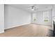 Bright living room with hardwood floors, a ceiling fan and a fireplace offers a cozy space at 2750 Lacy Holt Rd, Graham, NC 27253