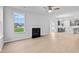 Bright open-plan living room featuring hardwood floors, fireplace, and connecting kitchen at 2750 Lacy Holt Rd, Graham, NC 27253