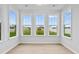 Bright sunroom features many large windows with lovely views and light wood floors at 2750 Lacy Holt Rd, Graham, NC 27253
