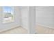 Bright walk-in closet with wire shelving and view of backyard at 2750 Lacy Holt Rd, Graham, NC 27253