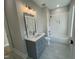 Modern bathroom with gray vanity, white subway tile, and bathtub at 314 Hinton St, Apex, NC 27502