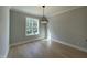 Breakfast room with hardwood floors and a modern light fixture at 314 Hinton St, Apex, NC 27502