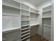 Bright walk-in closet, built-in shelves, and hanging rods at 314 Hinton St, Apex, NC 27502