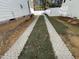 Long driveway with grass and pavers, offering ample parking at 314 Hinton St, Apex, NC 27502