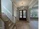 Bright entryway with hardwood floors, double doors, and elegant chandelier at 314 Hinton St, Apex, NC 27502
