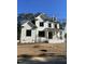 Two-story farmhouse style home with white brick and black shutters at 314 Hinton St, Apex, NC 27502