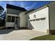 White two-car garage with screened porch and steps at 314 Hinton St, Apex, NC 27502