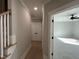 Light-filled hallway with hardwood floors and access to bedrooms at 314 Hinton St, Apex, NC 27502