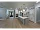 Modern kitchen featuring a large island, white cabinets, and quartz countertops at 314 Hinton St, Apex, NC 27502