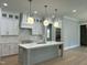 Modern kitchen with white cabinets, large island, and quartz countertops at 314 Hinton St, Apex, NC 27502