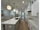 Modern kitchen with large island, white cabinets, and quartz countertops at 314 Hinton St, Apex, NC 27502