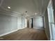 Main bedroom with hardwood floors, tray ceiling, and access to bathroom at 314 Hinton St, Apex, NC 27502