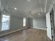 Bright main bedroom with hardwood floors, tray ceiling, and multiple windows at 314 Hinton St, Apex, NC 27502