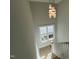View of a bright staircase with a modern light fixture at 314 Hinton St, Apex, NC 27502