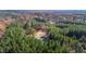 Aerial view of lush wooded acreage featuring a cleared area, ideal for building a dream home in a private setting at 3214 Tump Wilkins Rd, Stem, NC 27581