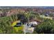 Aerial shot shows house, workshop and outbuildings surrounded by mature trees at 3214 Tump Wilkins Rd, Stem, NC 27581