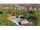 Aerial view features a home, outbuildings, and a vast expanse of lush forest at 3214 Tump Wilkins Rd, Stem, NC 27581