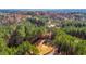 An aerial view showcases a large, private lot surrounded by lush greenery, offering an idyllic setting for a custom home at 3214 Tump Wilkins Rd, Stem, NC 27581