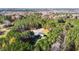 The aerial perspective highlights the house and wooded acreage in a verdant setting at 3214 Tump Wilkins Rd, Stem, NC 27581