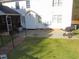 View of the backyard showing a screened porch and a pathway, ideal for outdoor enjoyment at 3214 Tump Wilkins Rd, Stem, NC 27581