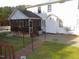 View of the backyard featuring a screened porch, pathway, and home's exterior at 3214 Tump Wilkins Rd, Stem, NC 27581
