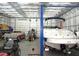 Spacious garage with lift, boat, truck, and mower at 3214 Tump Wilkins Rd, Stem, NC 27581
