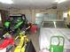View of the garage with two motorcycles, an ATV, and a covered car filling the space at 3214 Tump Wilkins Rd, Stem, NC 27581