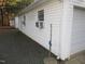 Exterior of the garage with white siding, multiple windows, and a small gravel area at 3214 Tump Wilkins Rd, Stem, NC 27581