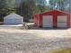 View of a large outbuilding featuring two garage doors, perfect for a workshop at 3214 Tump Wilkins Rd, Stem, NC 27581