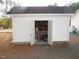 Shed with white siding featuring an open entry with tools and other yard equipment inside at 3214 Tump Wilkins Rd, Stem, NC 27581