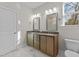 Double vanity bathroom with marble-look tile and a large shower at 35 Arbor Dr, Youngsville, NC 27596