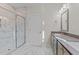 Bathroom with double vanity, marble-look tile and walk-in shower at 35 Arbor Dr, Youngsville, NC 27596