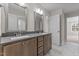 Double vanity bathroom with gray countertops and large mirrors at 35 Arbor Dr, Youngsville, NC 27596