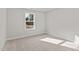 Bright bedroom with neutral carpeting and a window at 35 Arbor Dr, Youngsville, NC 27596