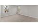 Well-lit bedroom with neutral carpeting and two windows at 35 Arbor Dr, Youngsville, NC 27596