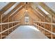 Unfinished bonus room with wood framing and window at 35 Arbor Dr, Youngsville, NC 27596