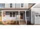 Front porch with brick steps leading to a wood front door at 35 Arbor Dr, Youngsville, NC 27596