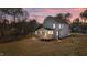 Gray house with wooden deck, and large backyard at dusk at 35 Arbor Dr, Youngsville, NC 27596