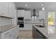 Kitchen with stainless steel appliances, granite countertops, white cabinets, and island sink at 35 Arbor Dr, Youngsville, NC 27596