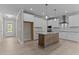 Spacious kitchen featuring white cabinetry, stainless steel appliances, and a center island with granite countertop at 35 Arbor Dr, Youngsville, NC 27596